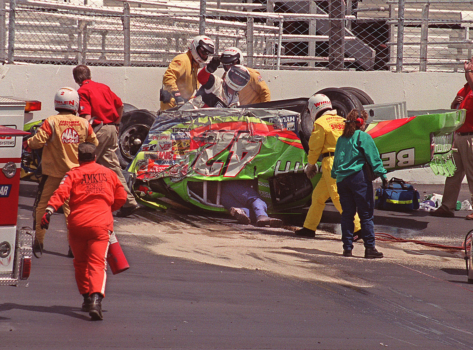 Rescue teams rush to Kenny Irwin's car after it crashed