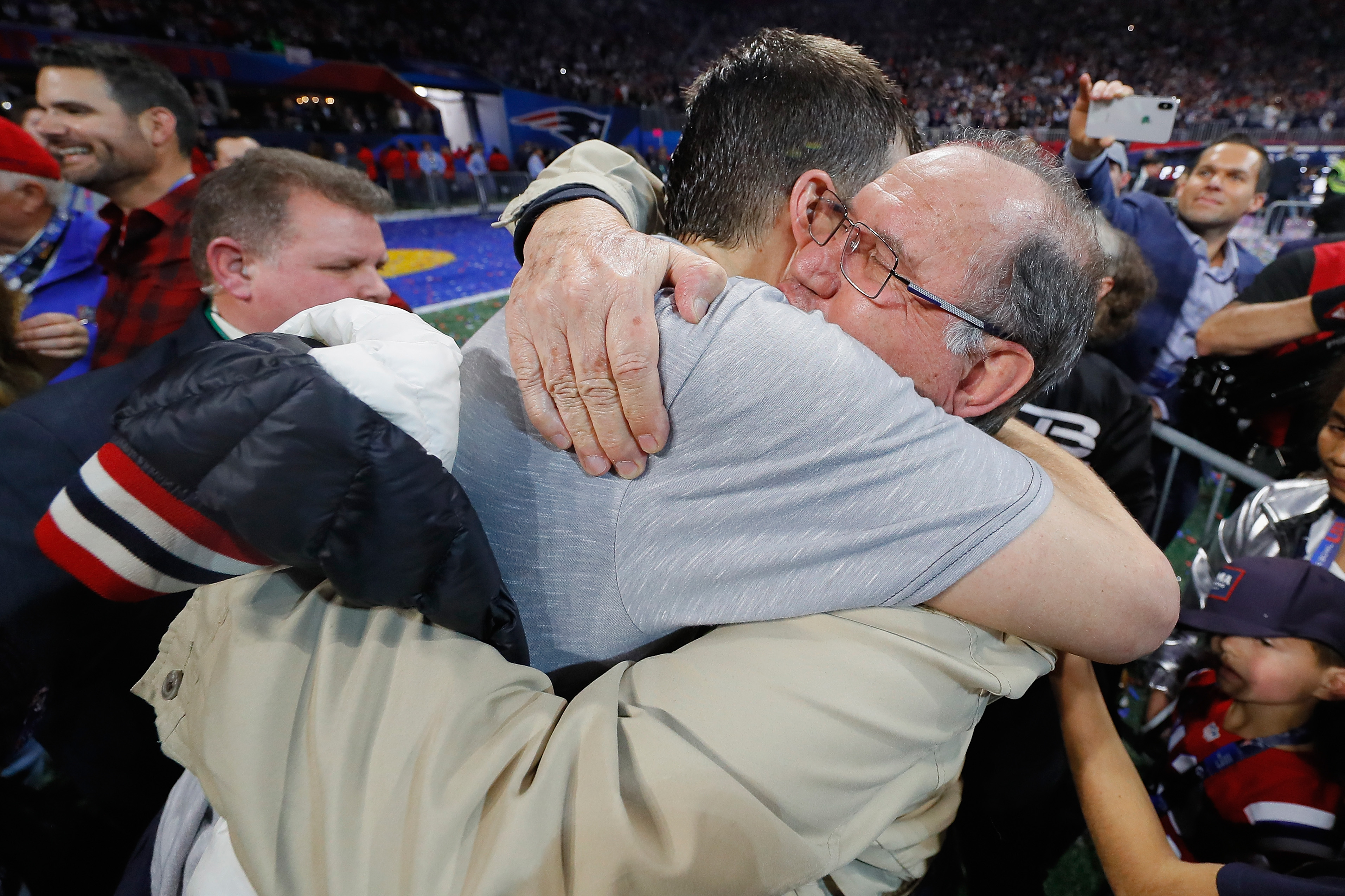 Quarterback Tom Brady hugs his dad
