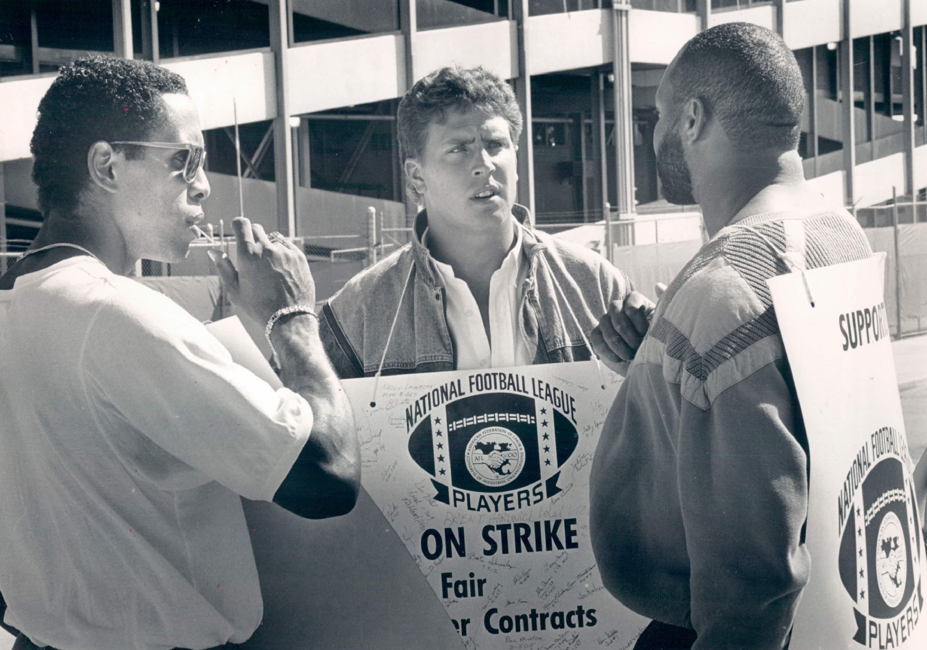 The 1987 NFL Strike at Mile Hi Stadium: Dan Merino (C) talks with Broncos players Dennis Smith (L) and Ricky Hunley of the NFLPA