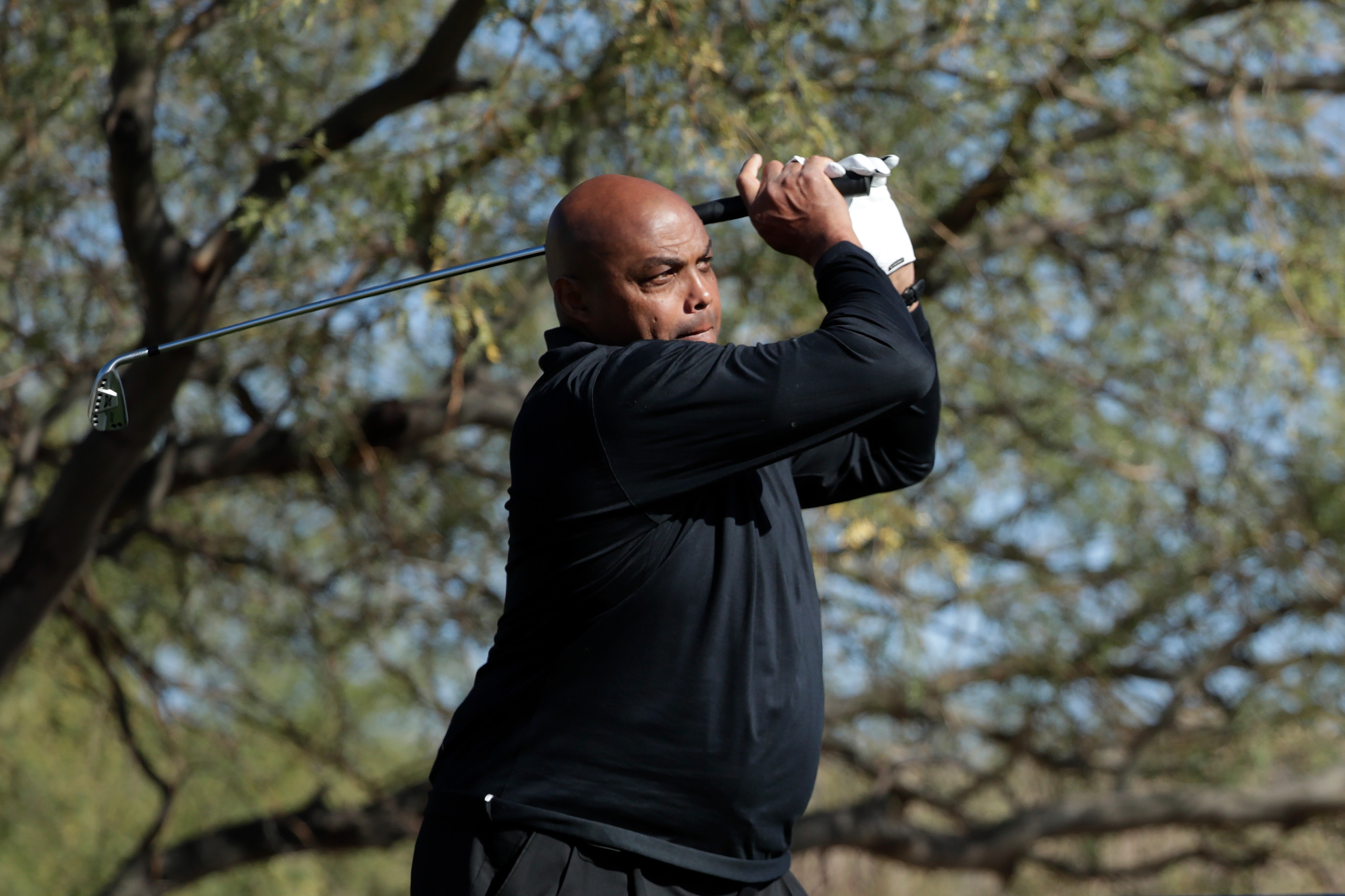 Charles Barkley plays his shot from the first tee