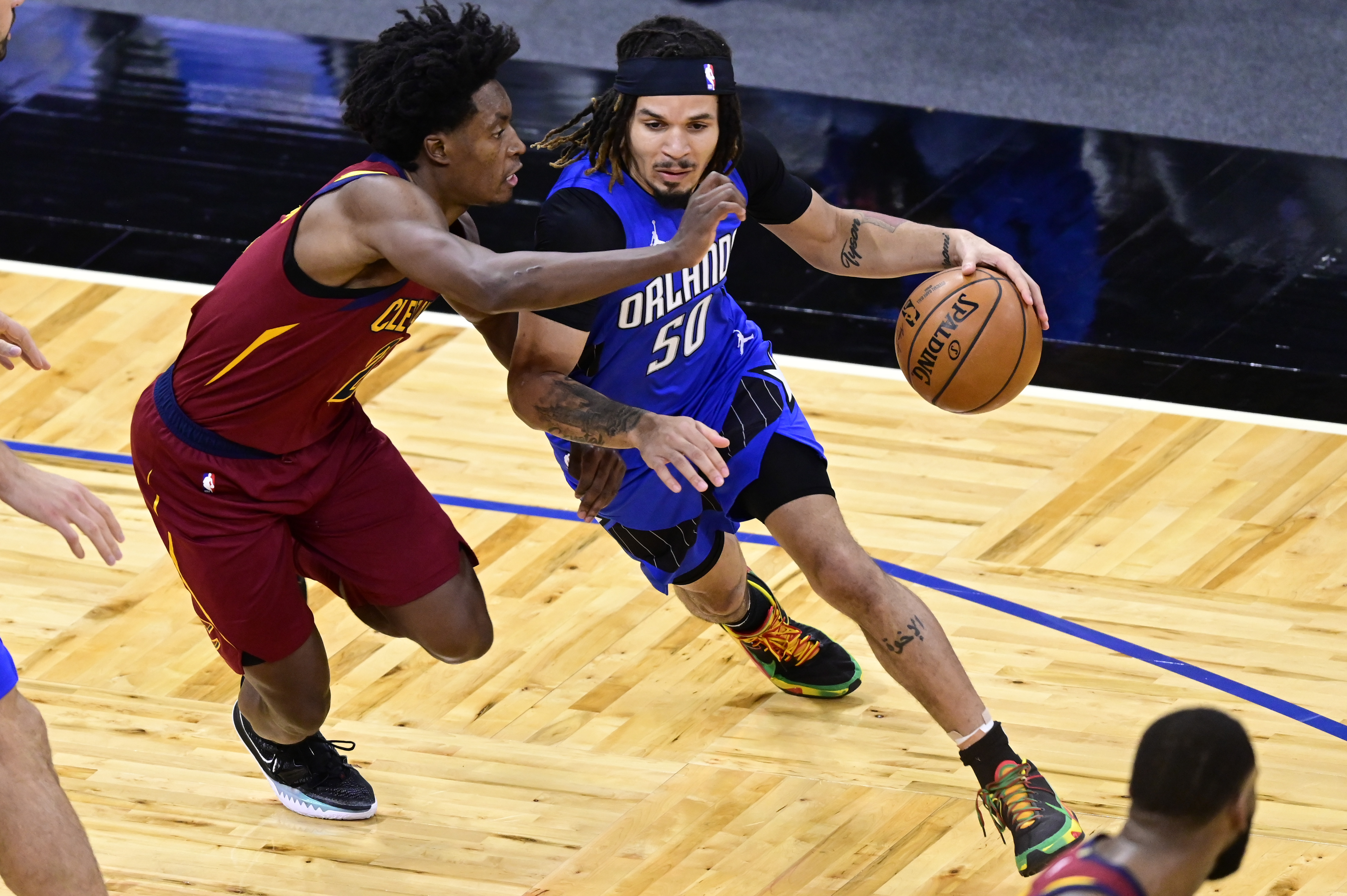 Cole Anthony of the Orlando Magic dribbles the ball as Collin Sexton of the Cleveland Cavaliers defends