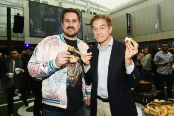 Dan "Big Cat" Katz and Dr. Oz hold up food at a media event