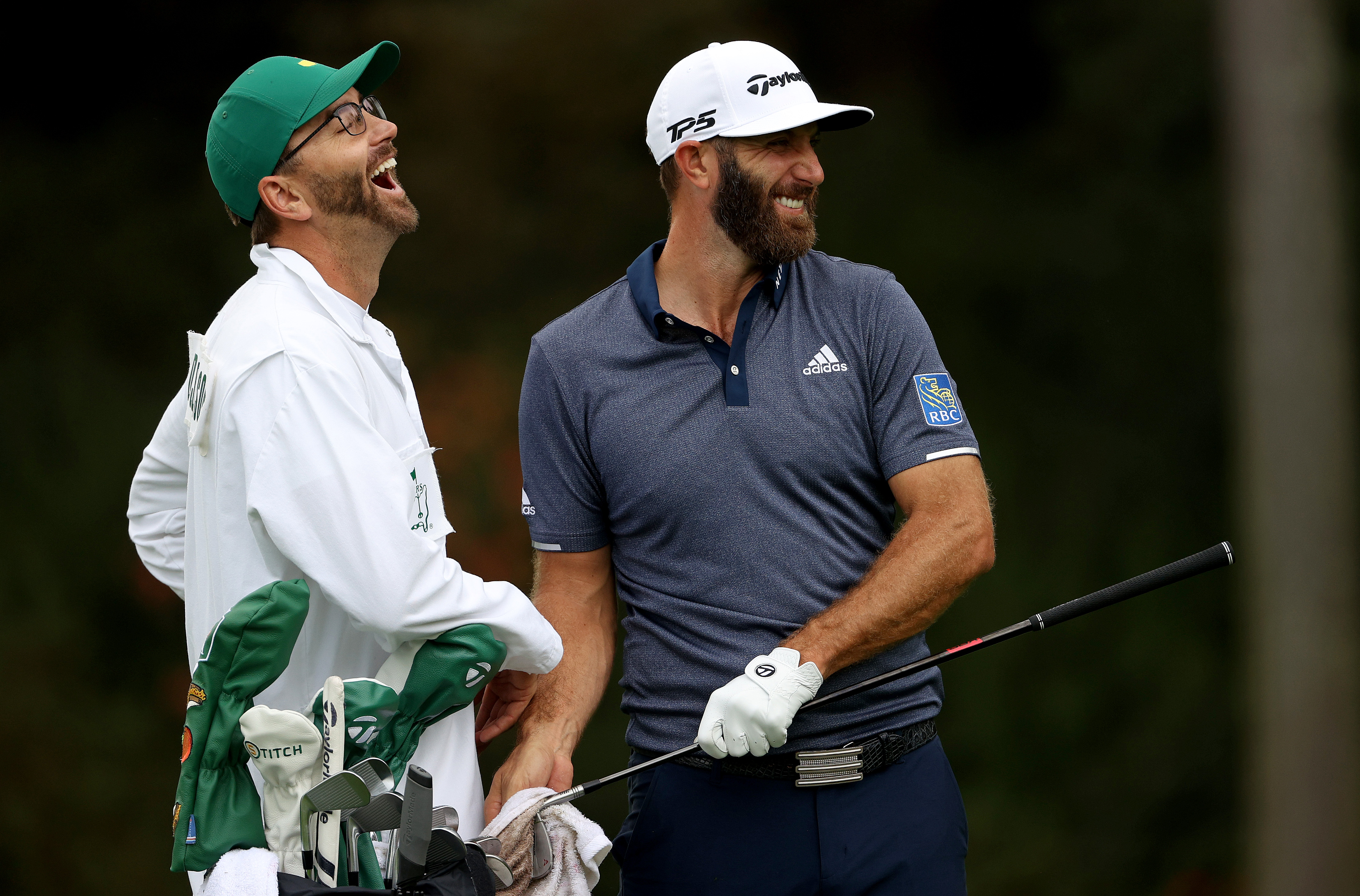 Dustin Johnson talks with his caddie and brother Austin Johnson