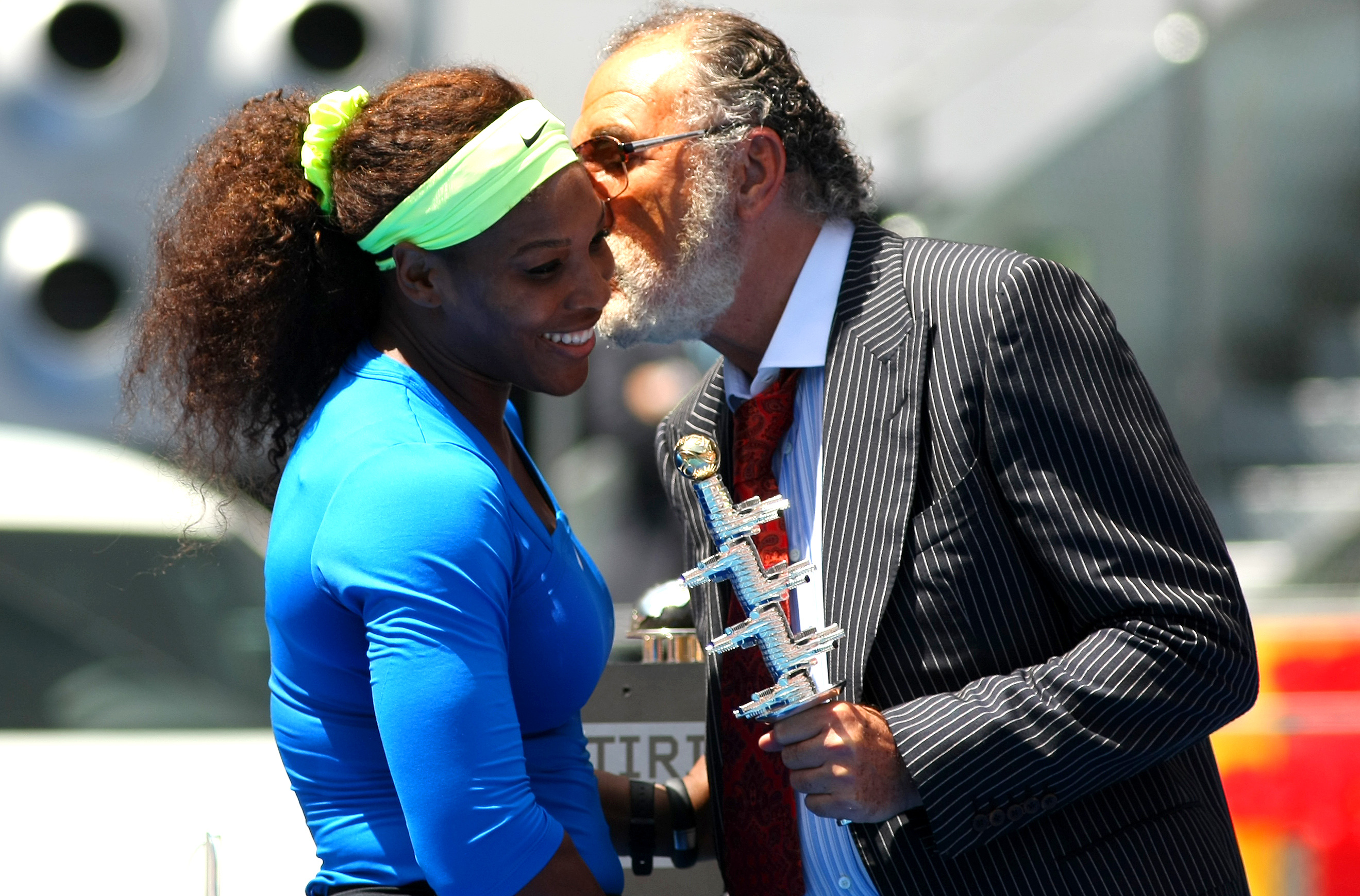 Serena Willams receives a kiss and the trophy from Ion Tiriac following her 2012 win in Madrid
