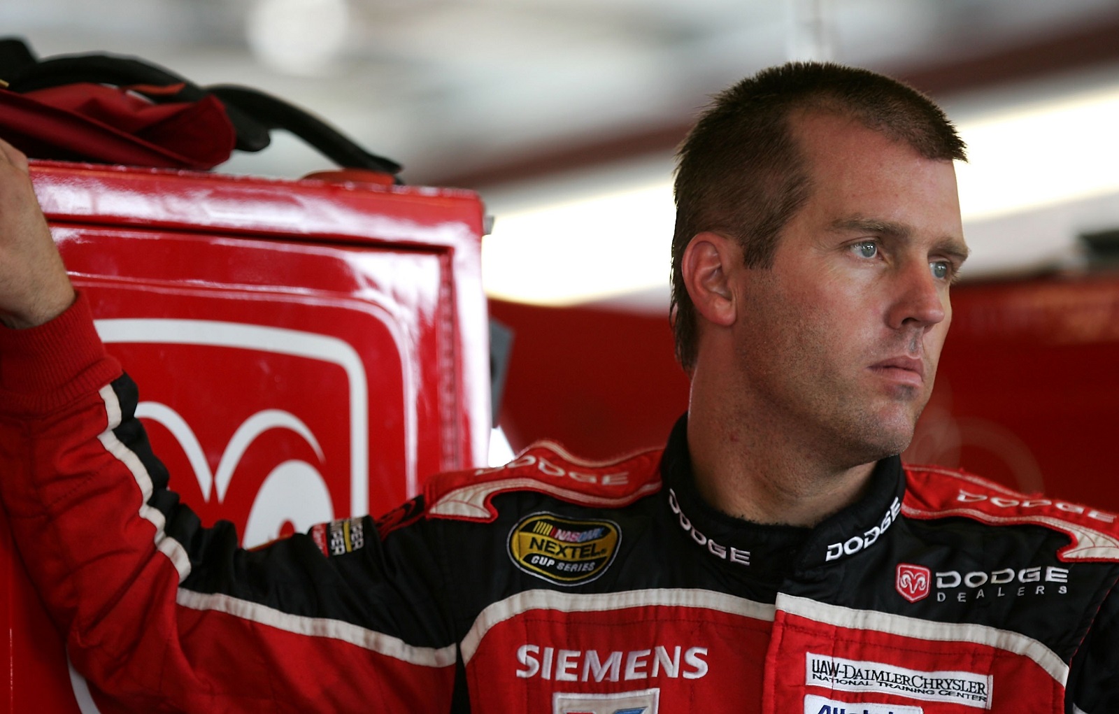 NASCAR driver Jeremy Mayfield stands by his car and looks out onto the track