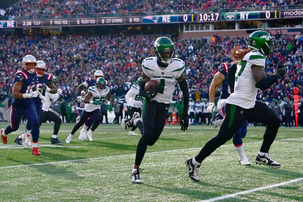 Sauce Gardner of the New York Jets carries the ball during a game against the New England Patriots.