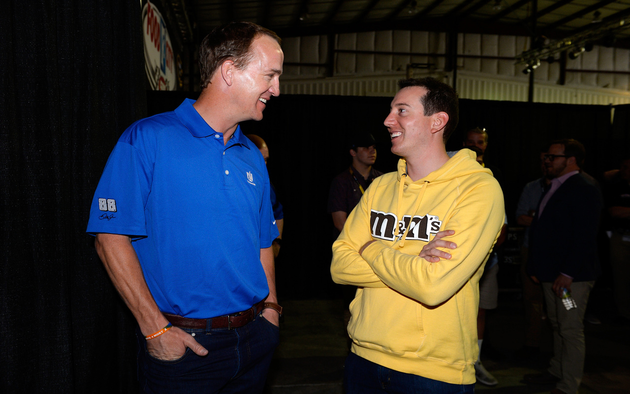 Longtime NFL quarterback Peyton Manning (L) spent time with NASCAR's Kyle Busch at the Food City 500 in April 2016. 