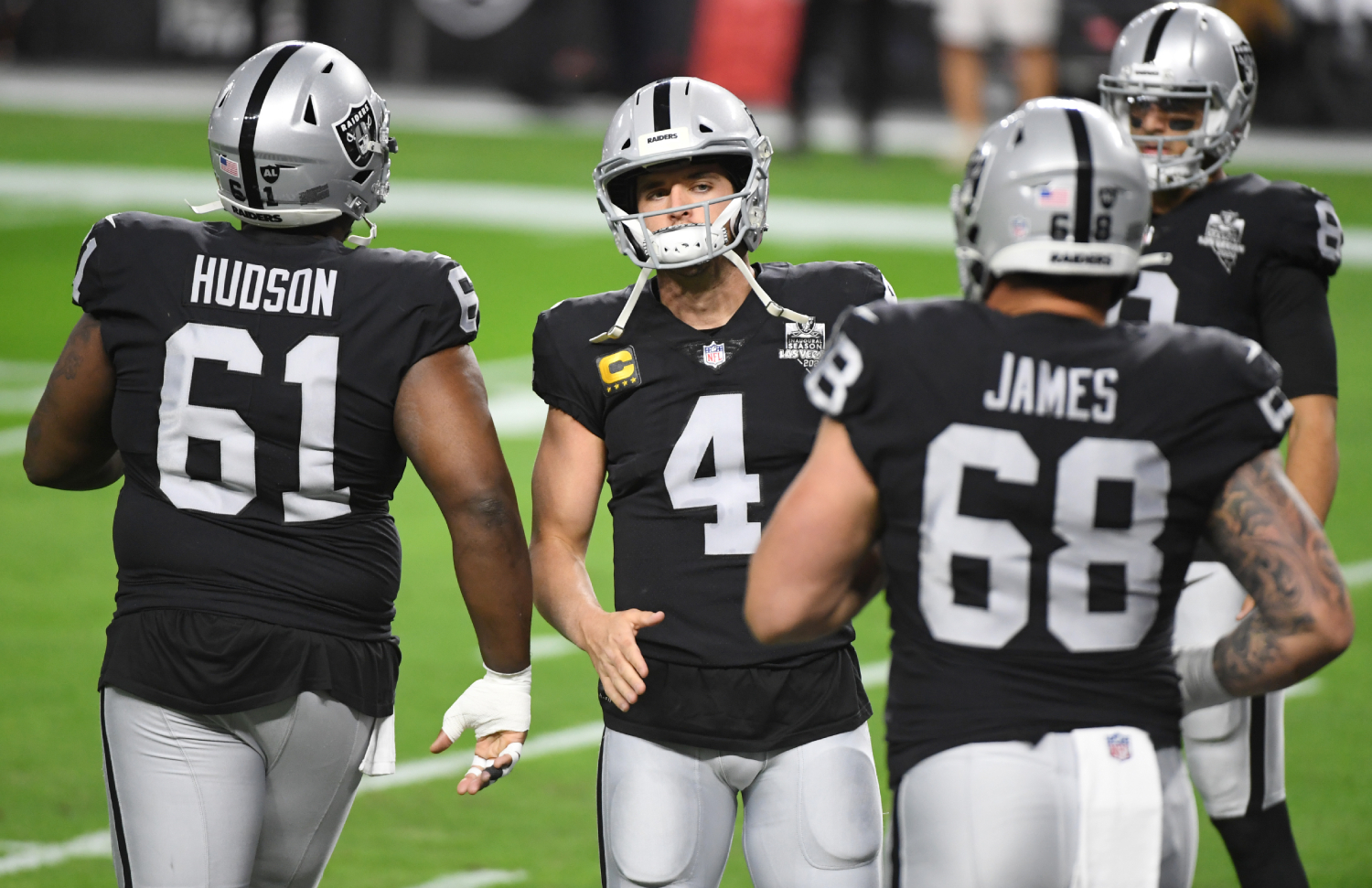 Members of the Las Vegas Raider run onto the field
