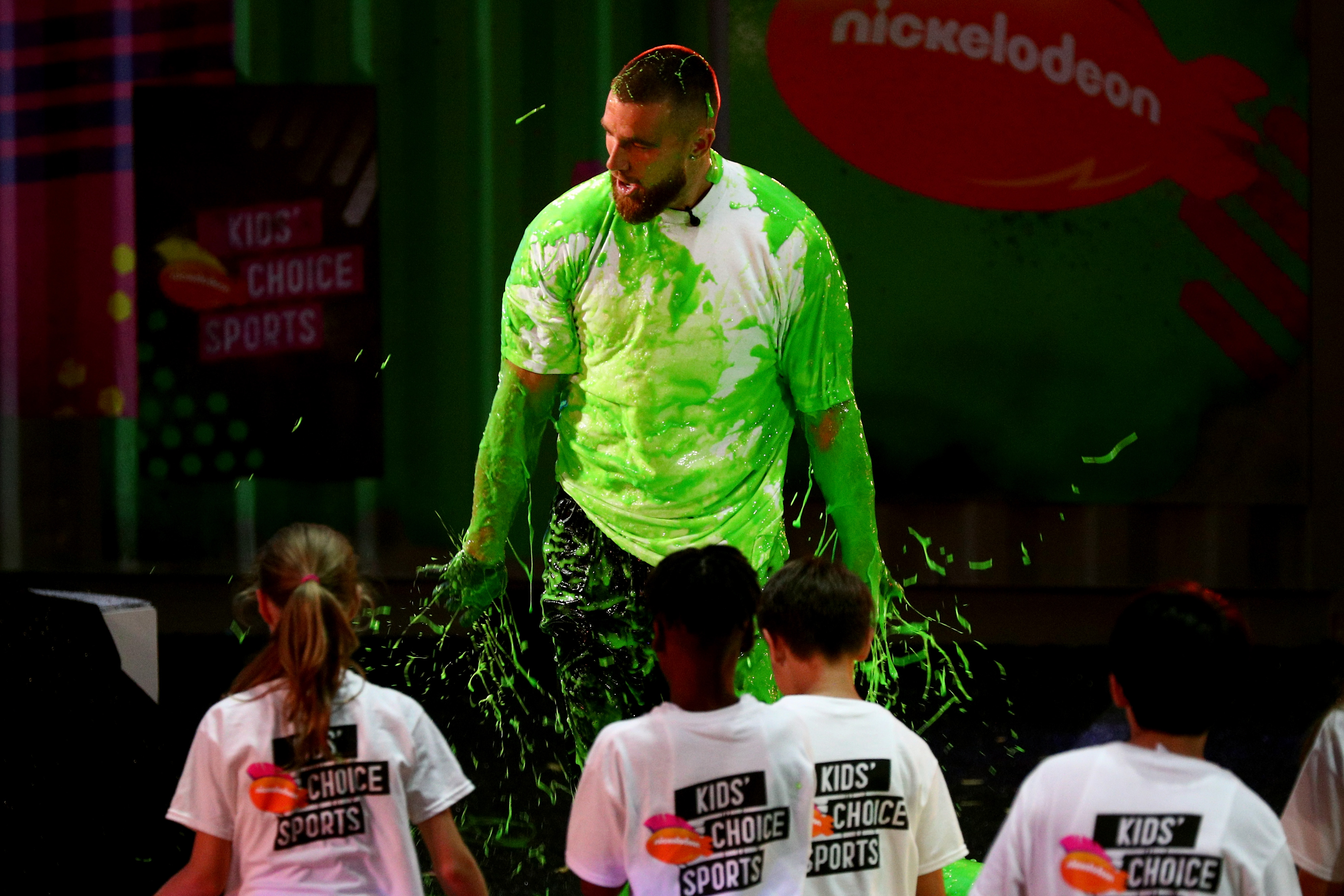 NFL player Travis Kelce reacts after being "slimed" onstage during the Nickelodeon Kids' Choice Sports 2018