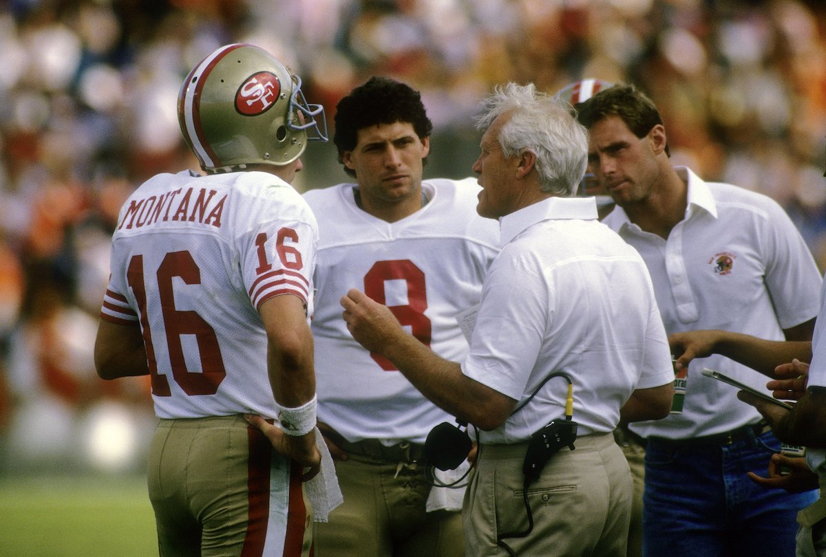 Quarterbacks Joe Montana and Steve Young talk to 49ers head coach Bill Walsh in 1988