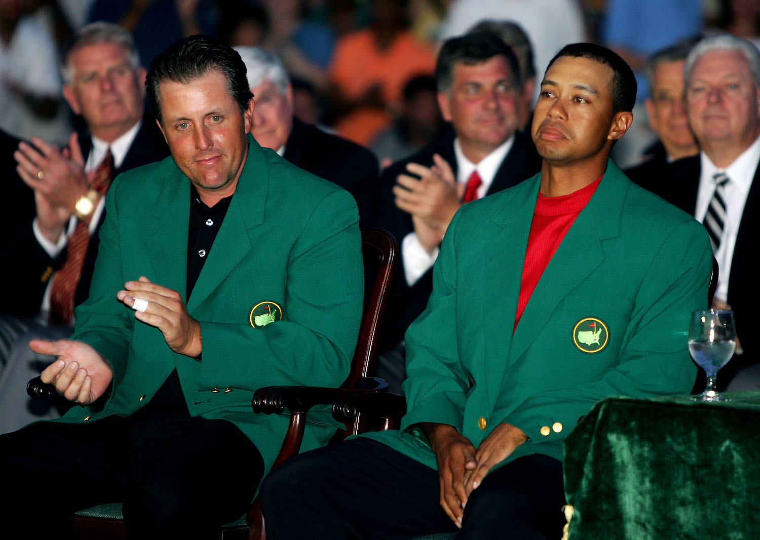 Tiger Woods sits beside Phil Mickelson