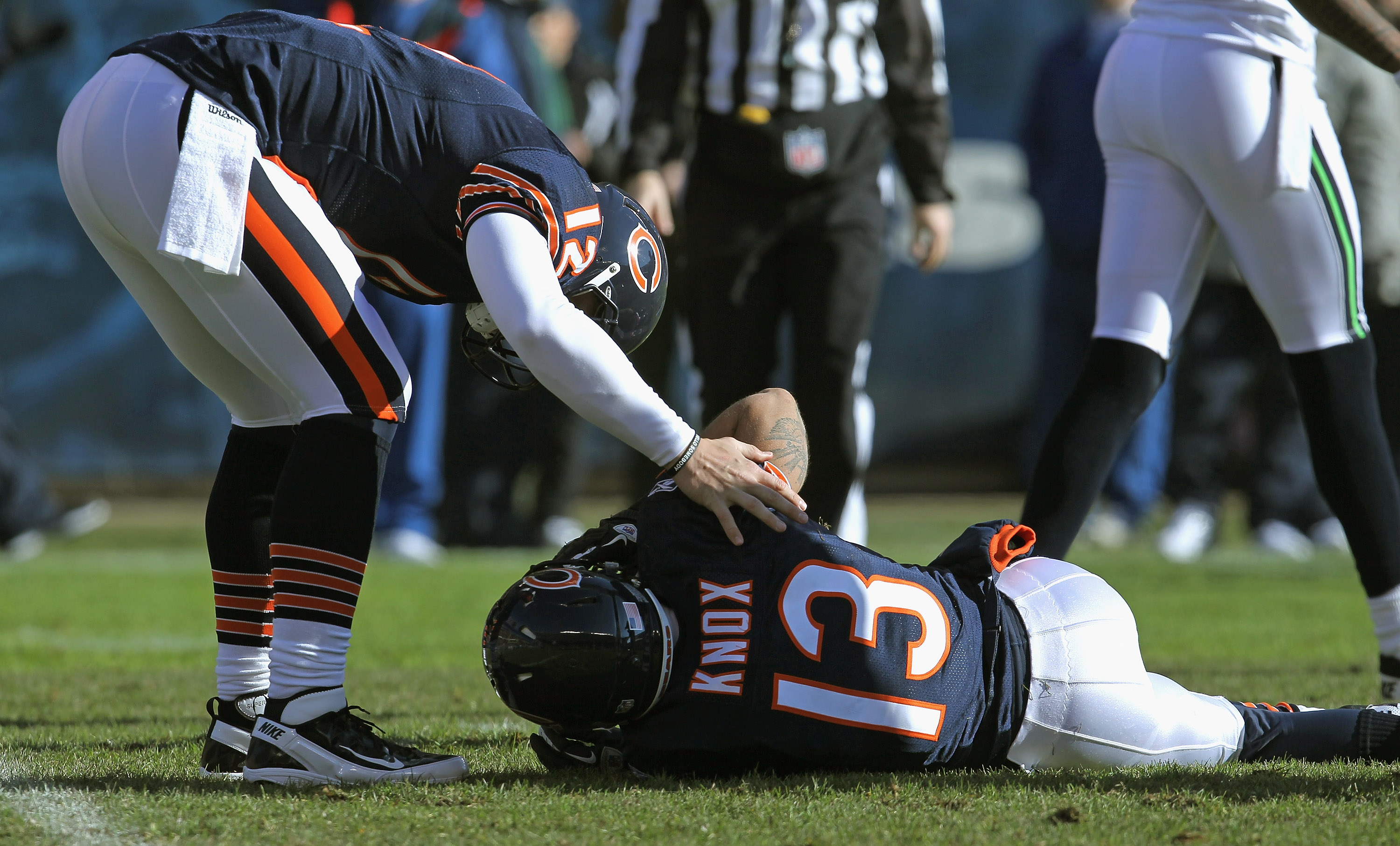 Bears player Johnny Knox lays on the field injured
