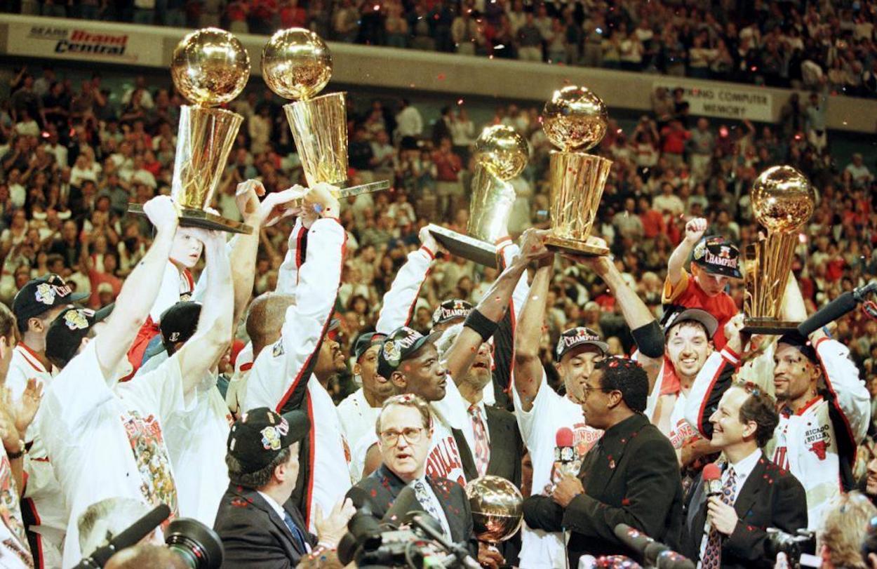 Michael Jordan and the Chicago Bulls celebrate after winning their fifth NBA title in seven years