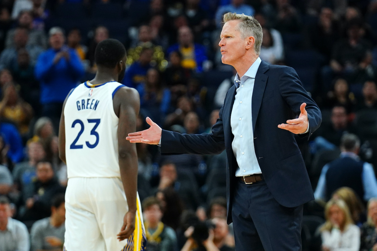 Draymond Golden State Warriors' Draymond Green walks off the court as Steve Kerr yells at the referee