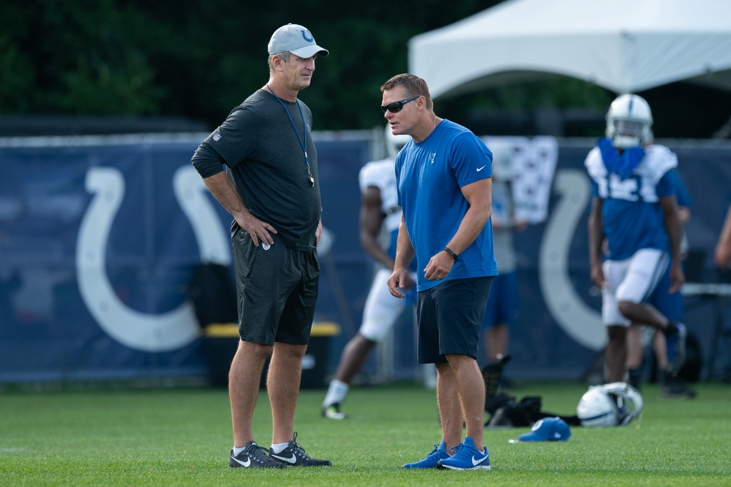 Indianapolis Colts general manager Chris Ballard talks to head coach Frank Reich on the field before the Indianapolis Colts training camp practice.
