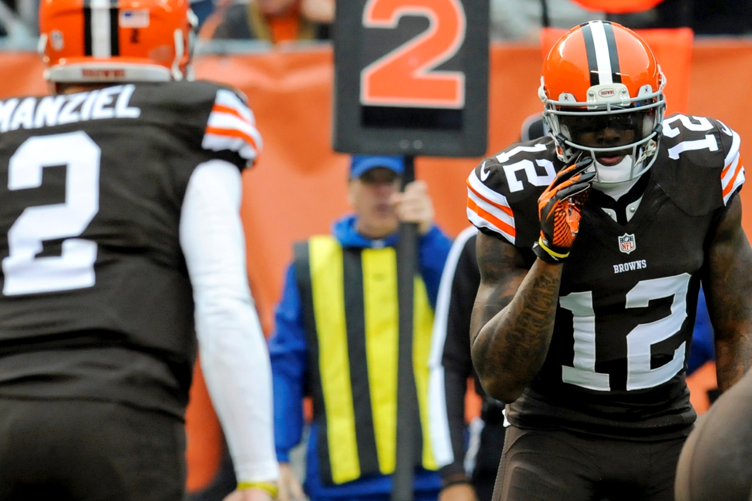 Josh Gordon of the Cleveland Browns listens to a call from quarterback Johnny Manziel in the second quarter of a game against the Cincinnati Bengals.