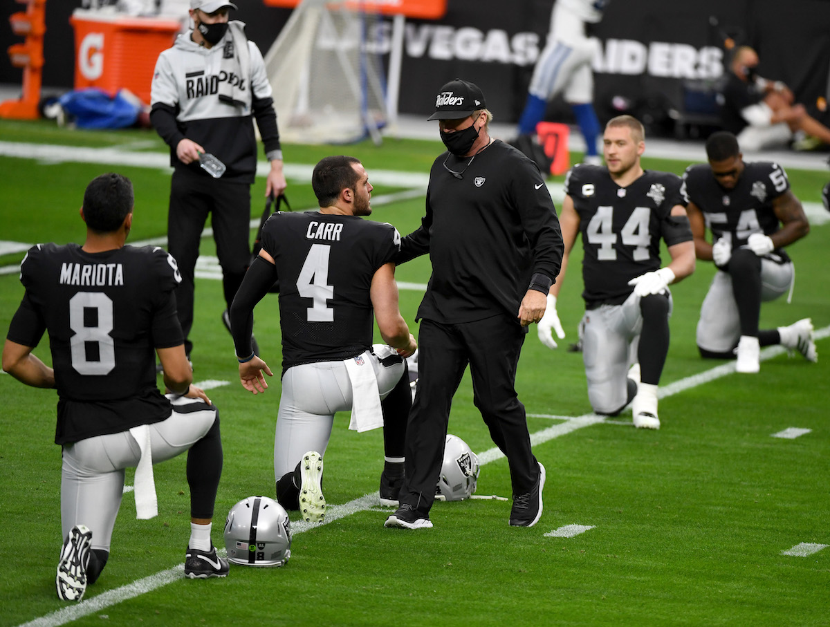 Las Vegas Raiders coach Jon Gruden talks with his quarterbacks before a game