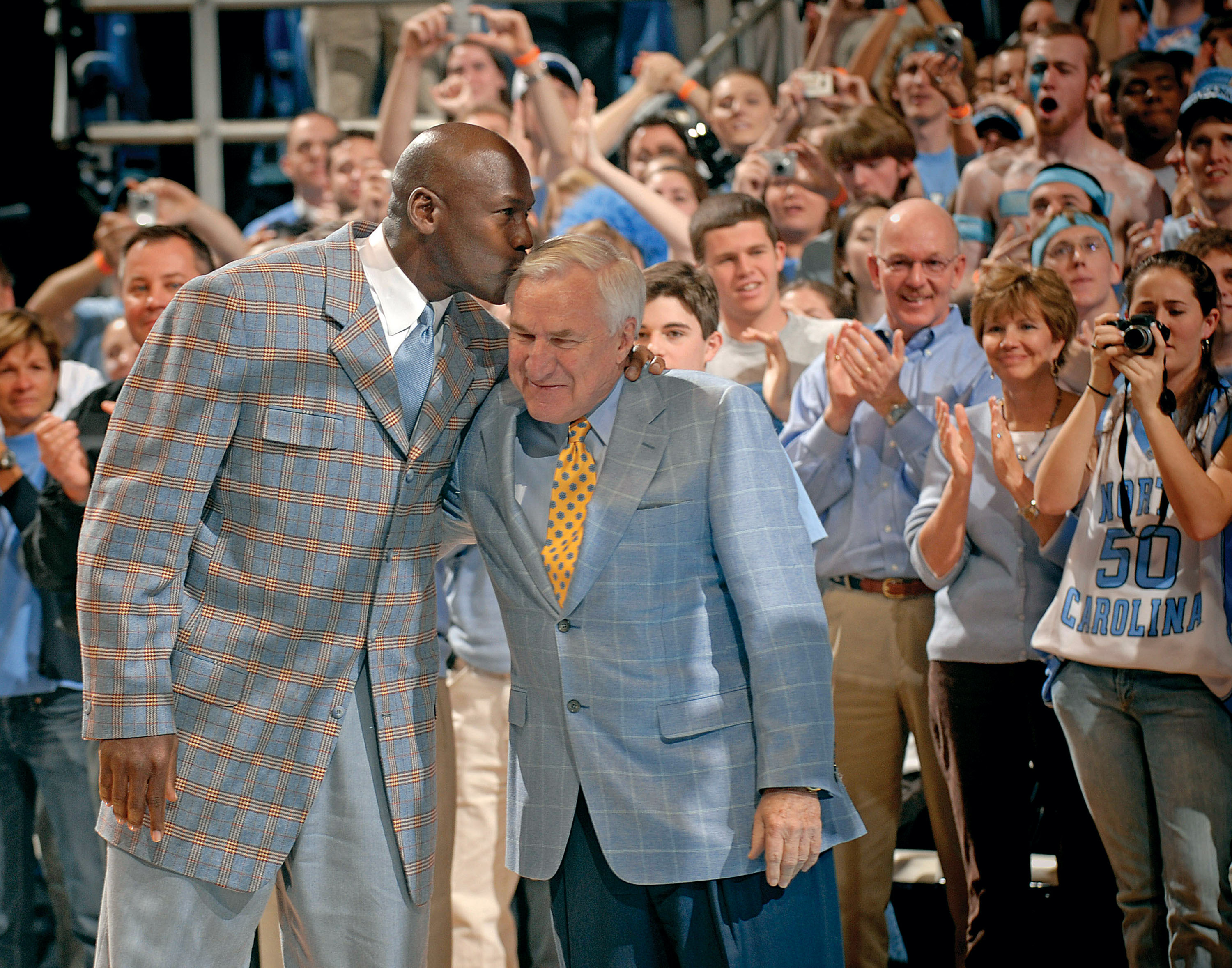 Michael Jordan kisses former coach Dean Smith of the North Carolina Tar Heels during a halftime ceremony honoring the 1993 national championship team