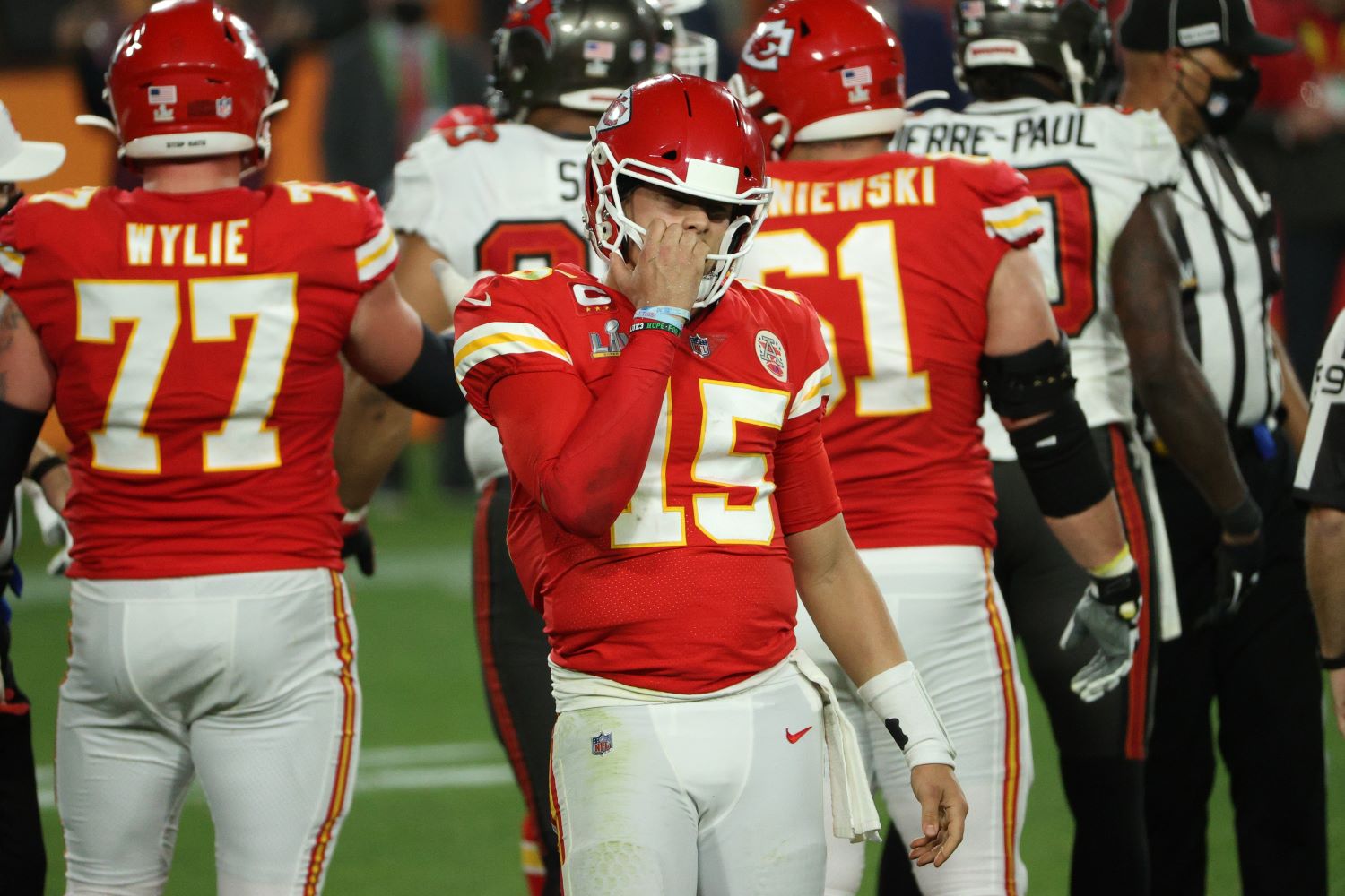 Chiefs quarterback Patrick Mahomes grabs his facemask during Super Bowl 55.