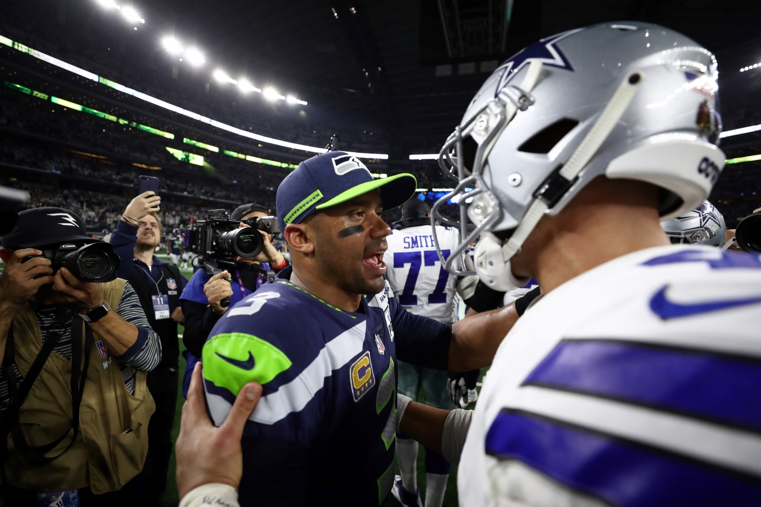 Dak Prescott of the Dallas Cowboys talks with Russell Wilson of the Seattle Seahawks after the Cowboys defeated the Seahawks 24-22 in the Wild Card Round.