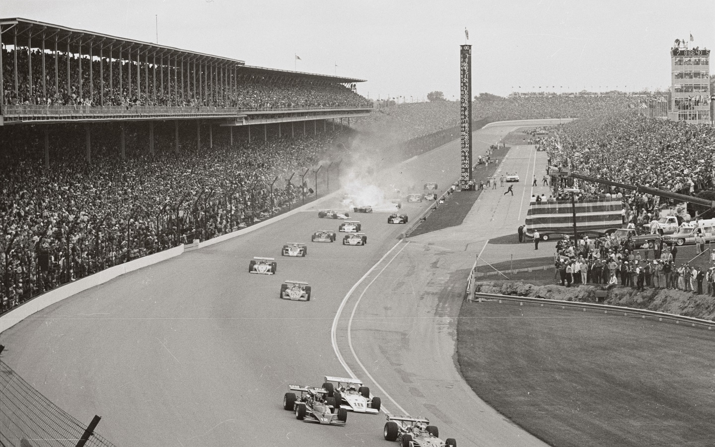 Huge ball of fire covers the track as the car of Salt Walther spins across the main stretch after hitting the outside wall just as the field of 32 cars began the first lap of the Indy 500