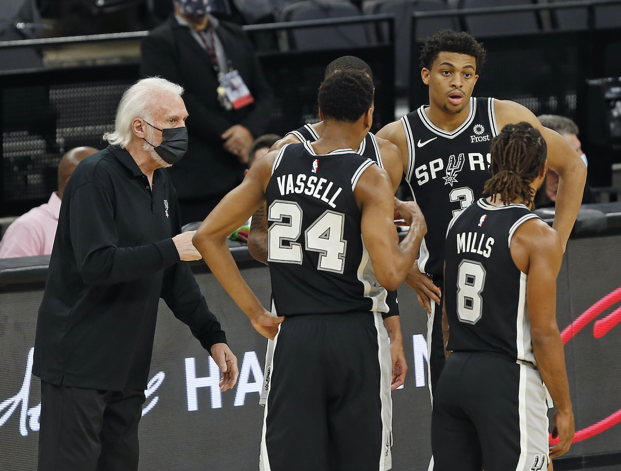 Gregg Popovich and the San Antonio Spurs huddle during a game against the Minnesota Timberwolves