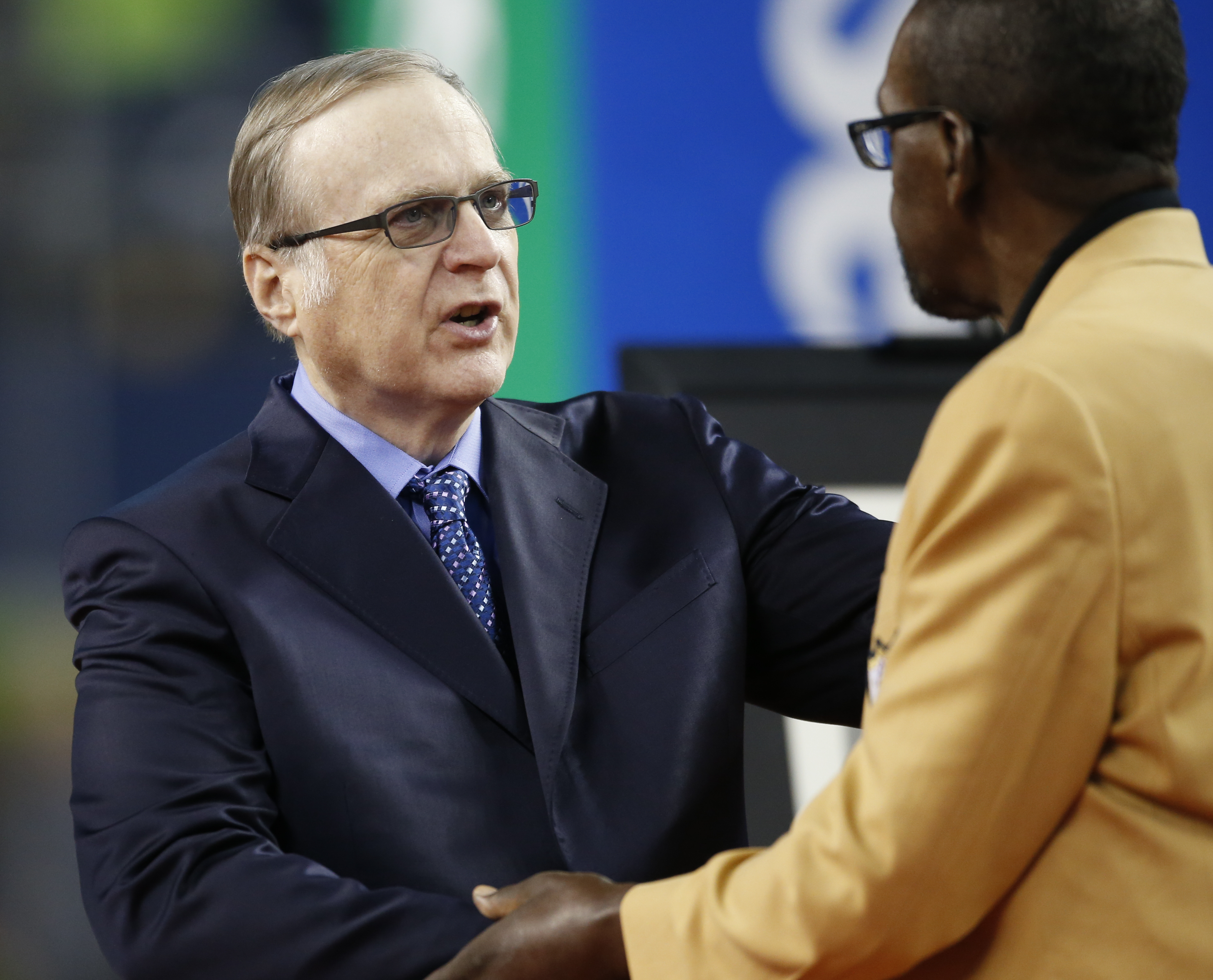 Late Seahawks owner Paul Allen greets an NFL Hall of Fame member in 2017