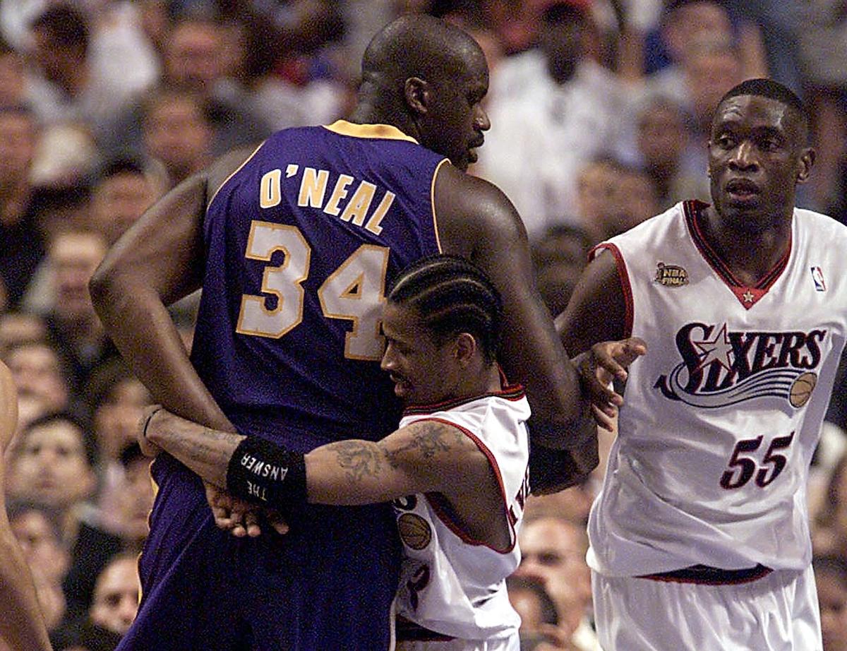 Shaquille O'Neal is being grabbed by Allen Iverson