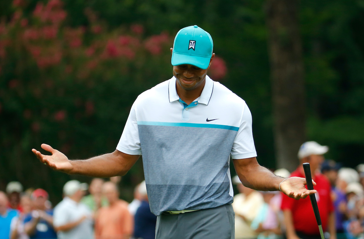 Tiger Woods shrugs after making a birdie putt at the 2015 Wyndham Championship