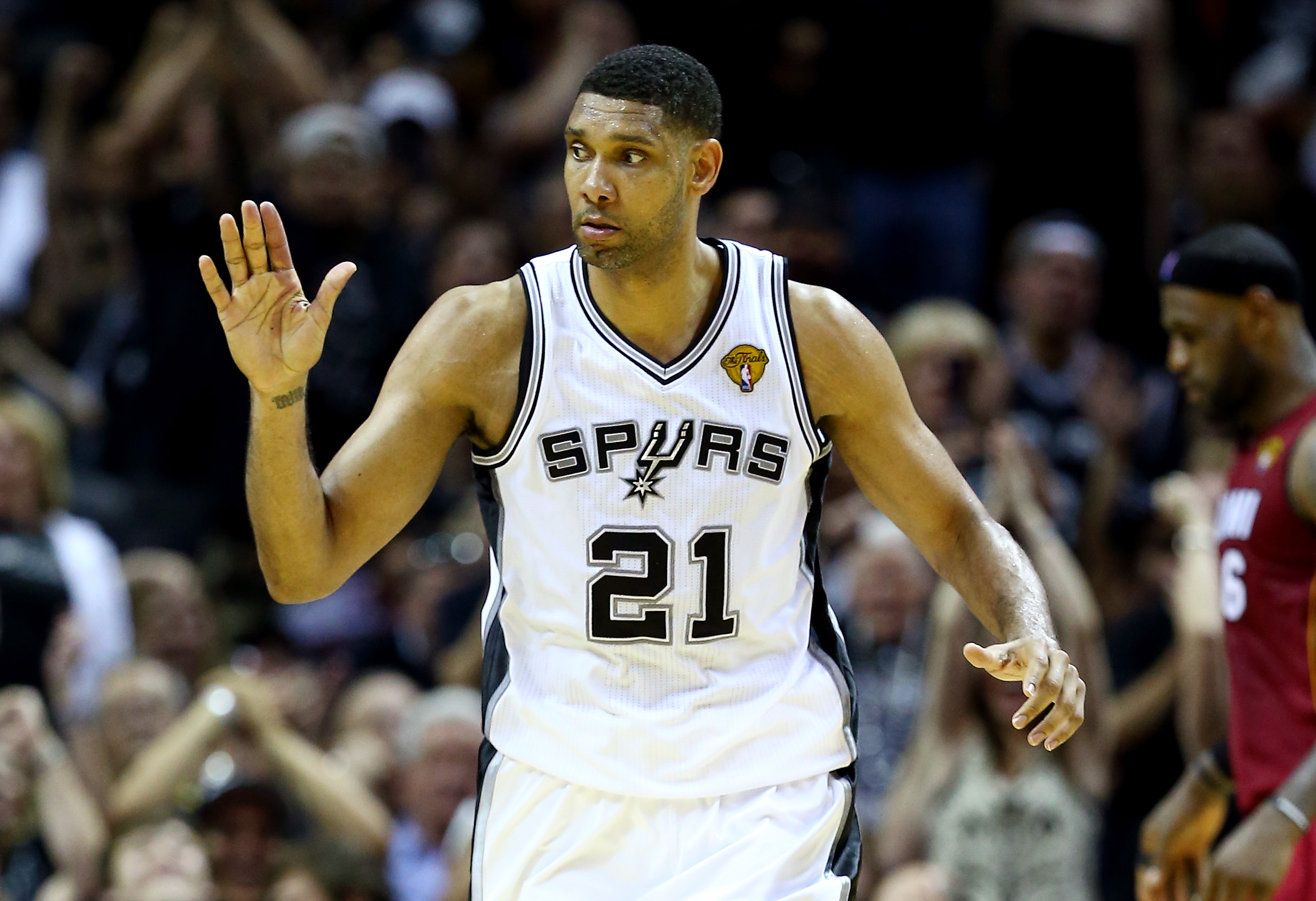 Tim Duncan celebrates after making a shot during a Spurs game