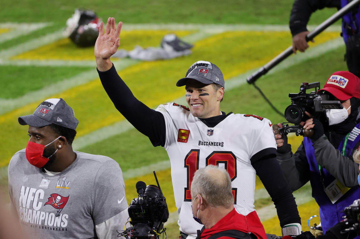 Tom Brady walks off the field after beating the Packers in the NFC Championship