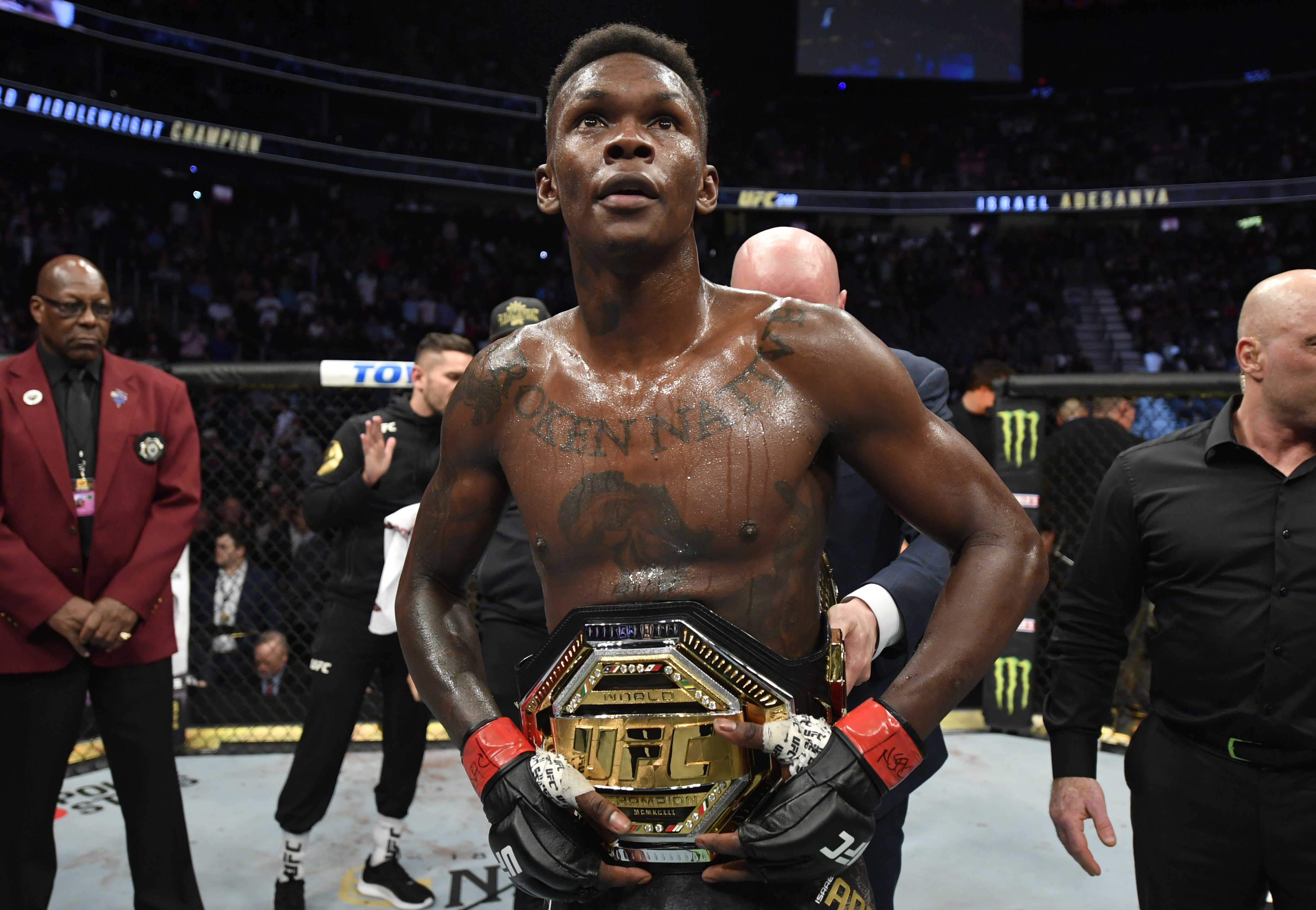 Israel Adesanya celebrates after defeating Yoel Romero in their UFC middleweight championship fight during UFC 248