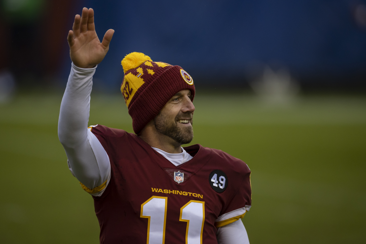 Alex Smith waves to football fans after a game