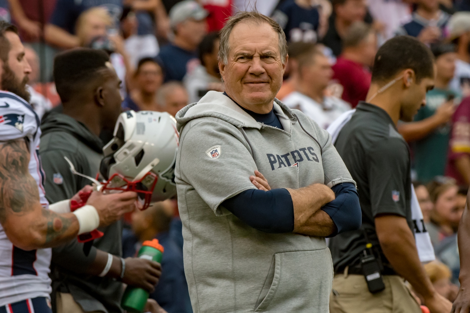 New England Patriots head coach Bill Belichick stands with his arms crossed during a game against the Washington Football Team from the 2019 season.