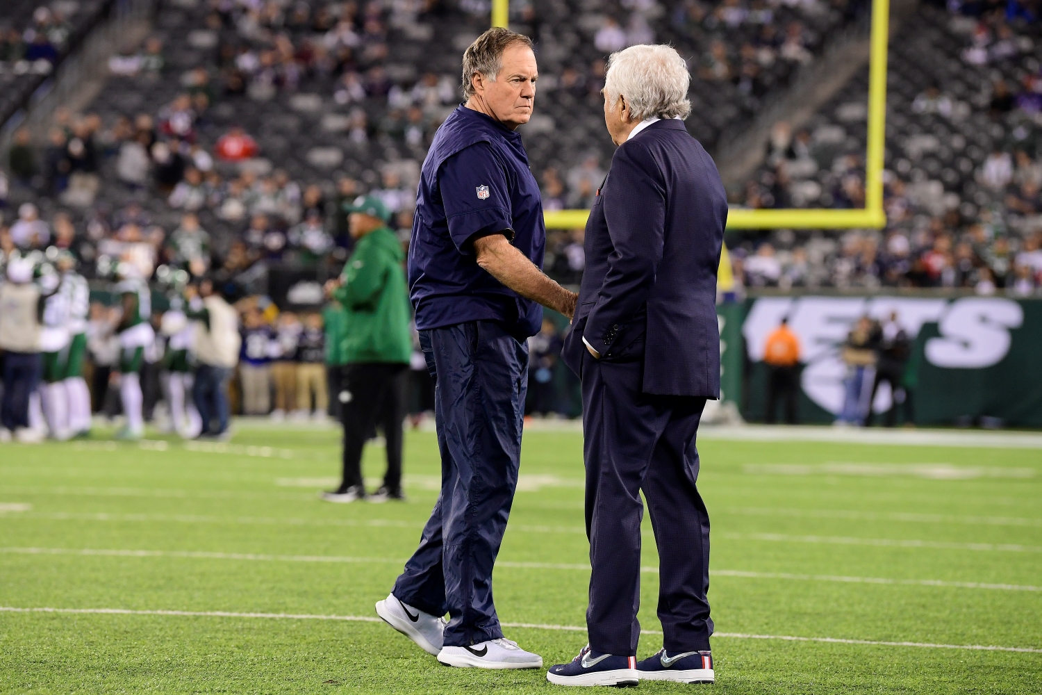 Bill Belichick shakes hands with New England Patriots owner Robert Kraft before a game.