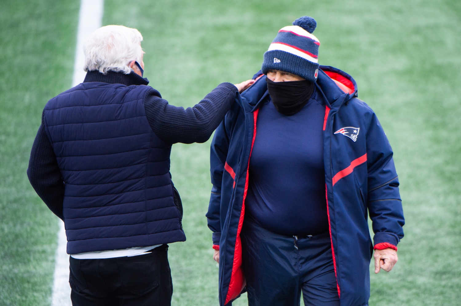 New England Patriots owner Robert Kraft pats head coach Bill Belichick on the shoulder during warmups prior to the start of the game against the New York Jets at Gillette Stadium in January 2021.