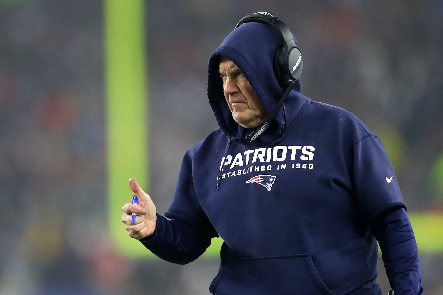 New England Patriots head coach and general manager Bill Belichick stands on the sidelines