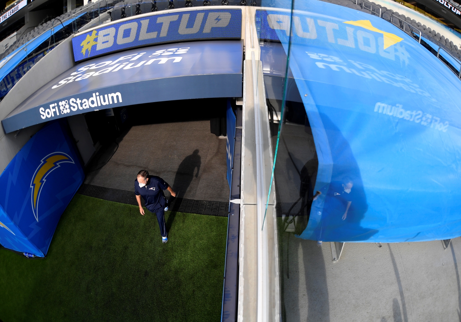 Bill Belichick walks out onto the field before a game between the New England Patriots and the LA Chargers during the 2020 NFL season.