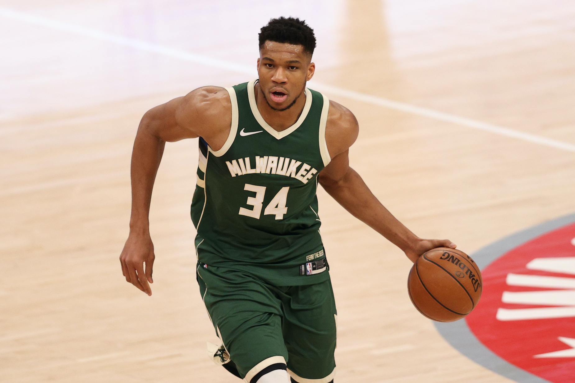 Milwaukee Bucks star Giannis Antetokounmpo dribbles the ball in NBA action.