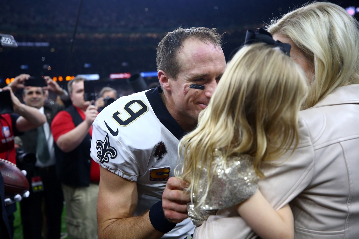New Orleans Saints quarterback Drew Brees celebrates with his family after he broke the NFL's all-time passing yards record on Oct. 8, 2018.