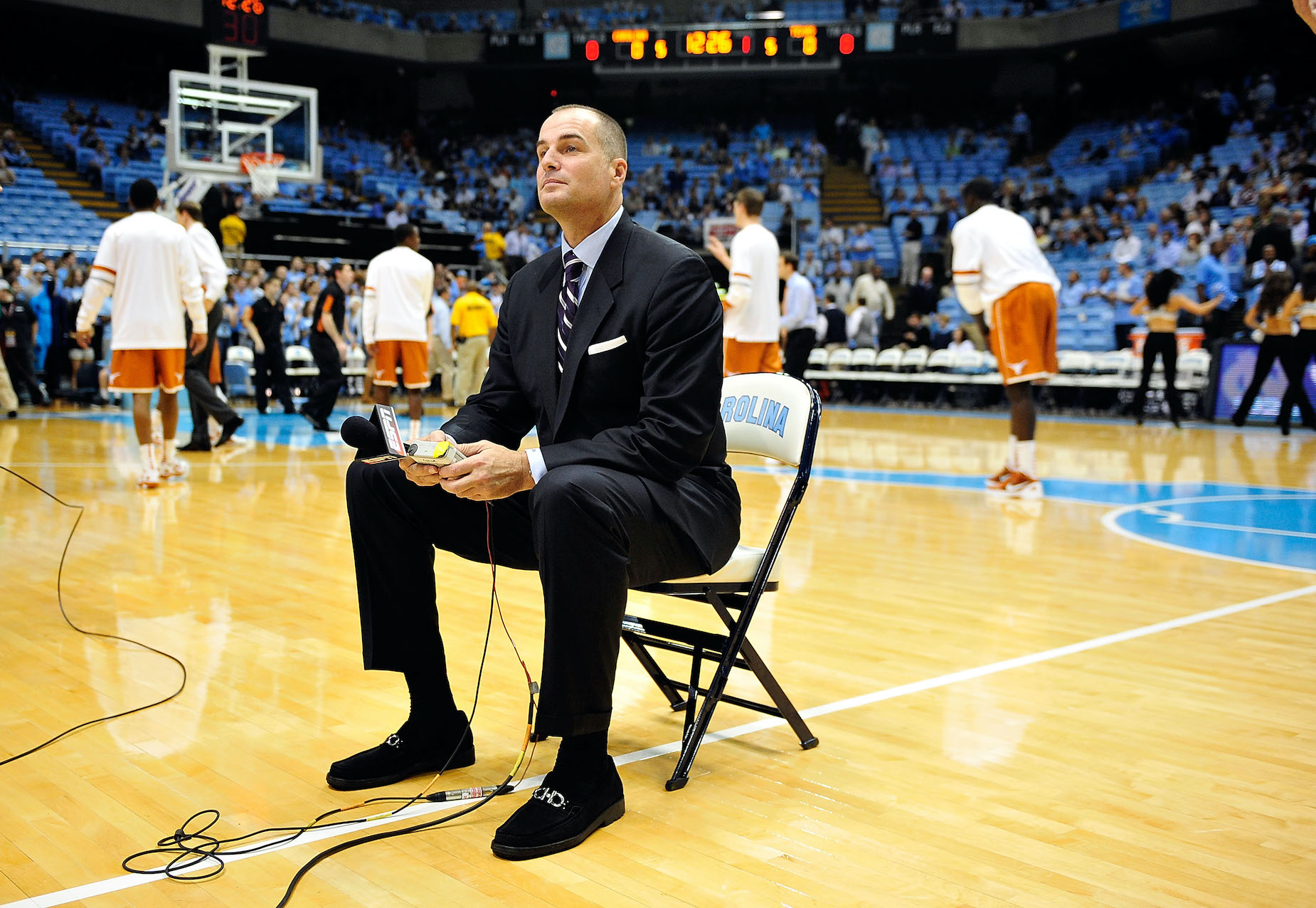 Former player turned ESPN analyst Jay Bilas sits on the court pregame