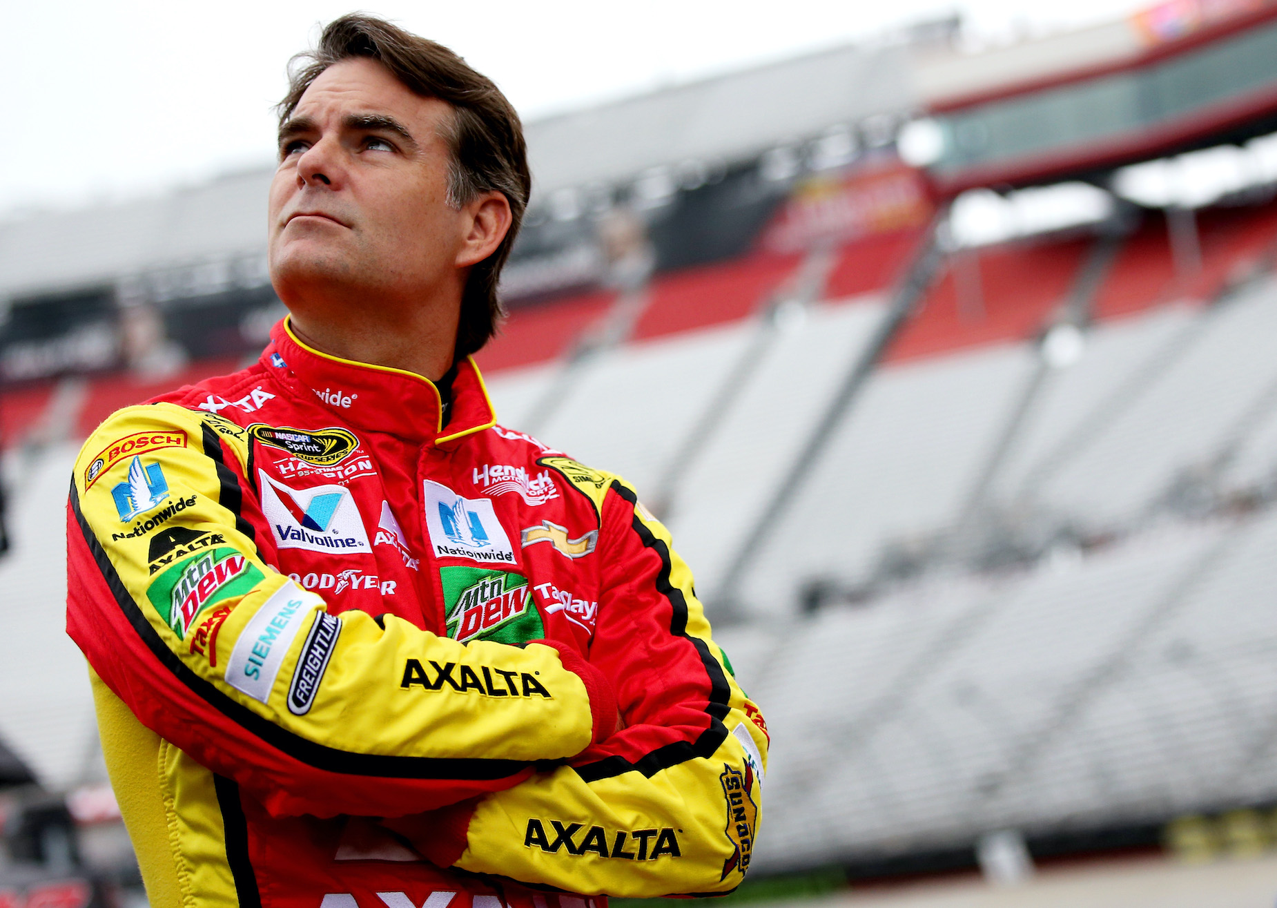 NASCAR star Jeff Gordon stands outside of his car during practice.