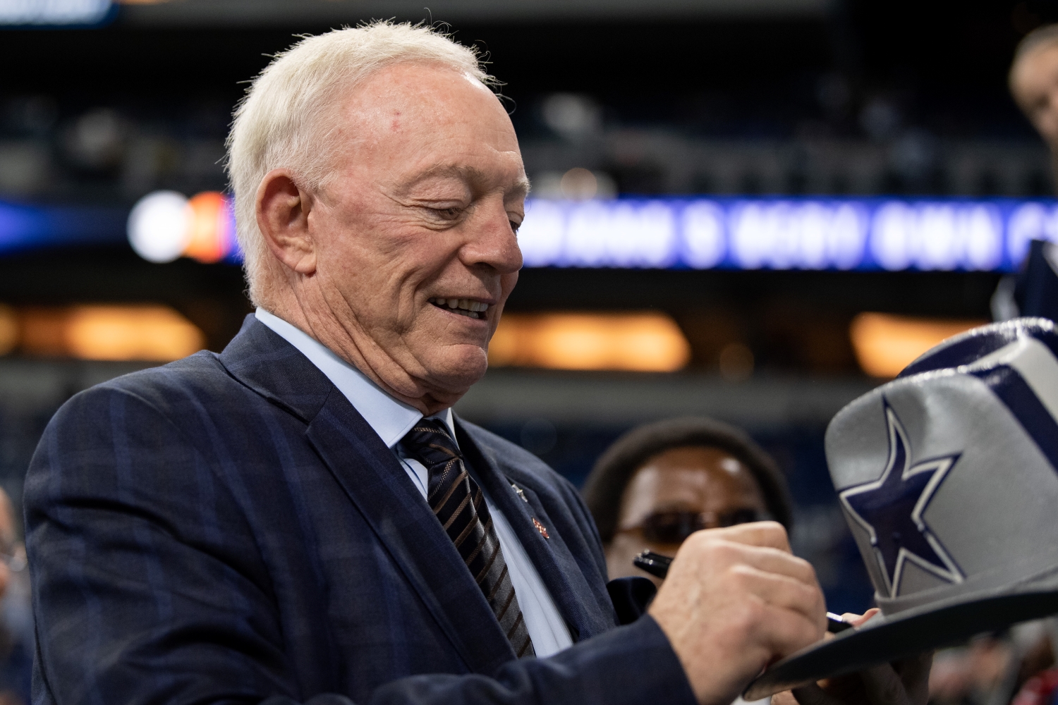 Dallas Cowboys owner Jerry Jones signs autographs before a game against the Indianapolis Colts from the 2018 season.
