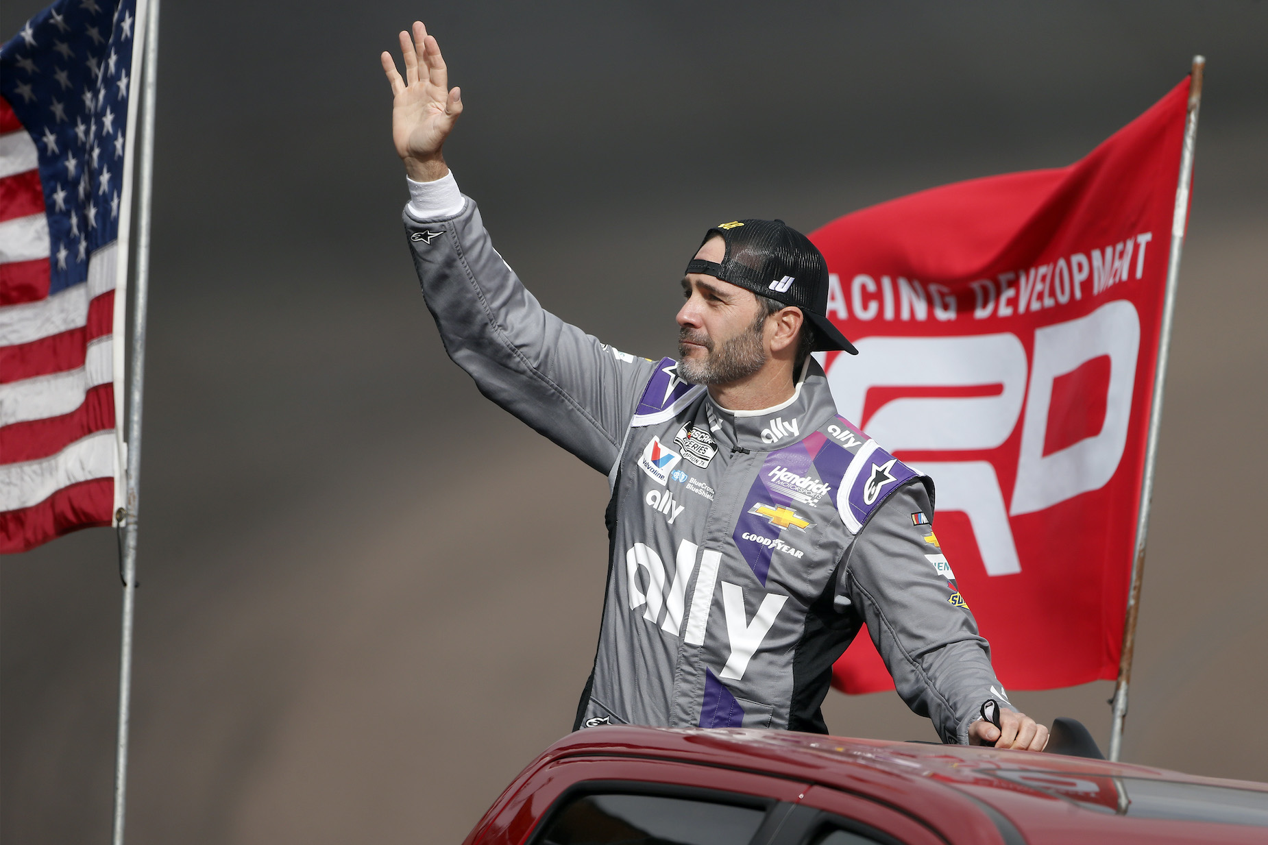 Jimmie Johnson waves to NASCAR fans.
