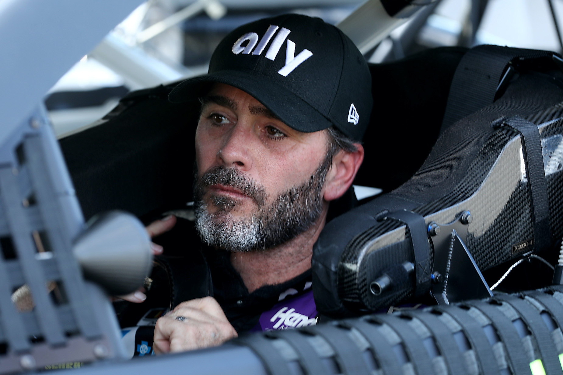 NASCAR driver Jimmie Johnson sits in the driver's seat