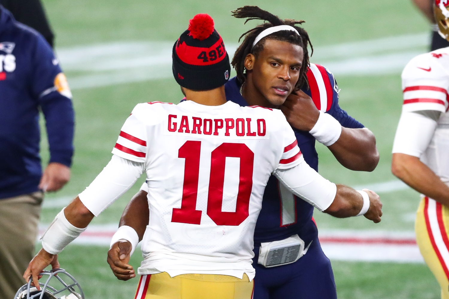 San Francisco 49ers quarterback Jimmy Garoppolo embraces New England Patriots quarterback Cam Newton.