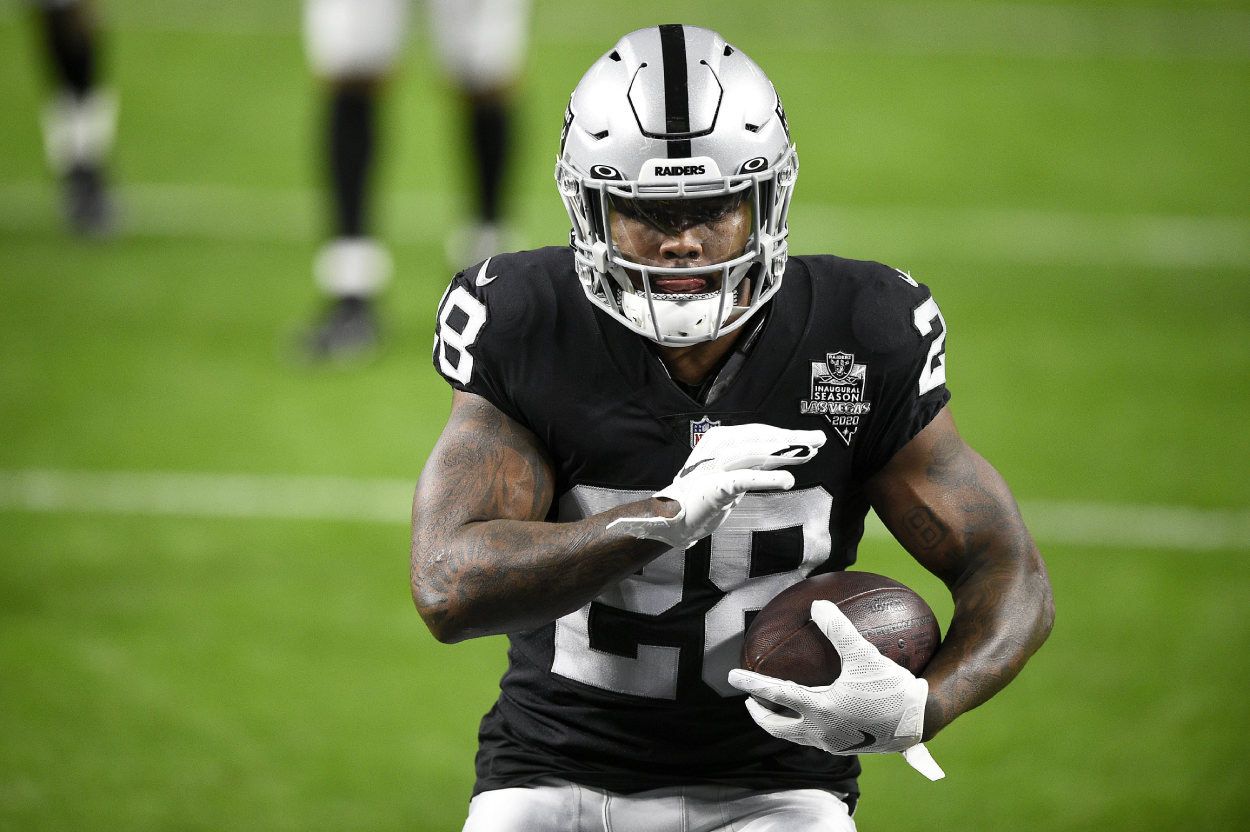 Josh Jacobs carrying the ball during a Raiders game