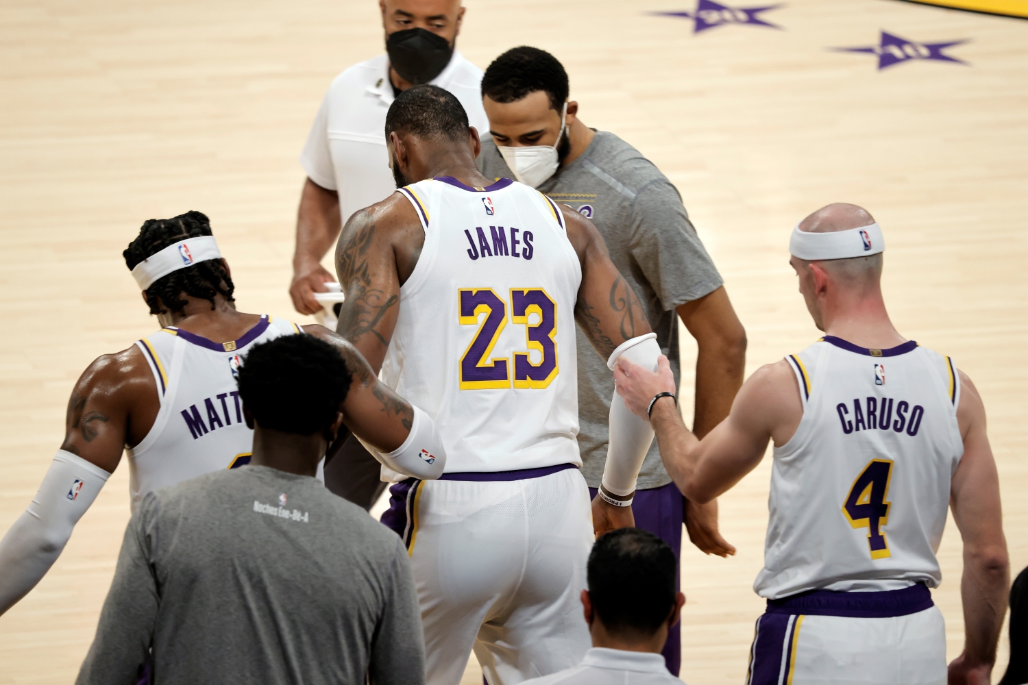 LeBron James receives help from his Lakers teammates after suffering an injury against the Atlanta Hawks on March 20, 2021.