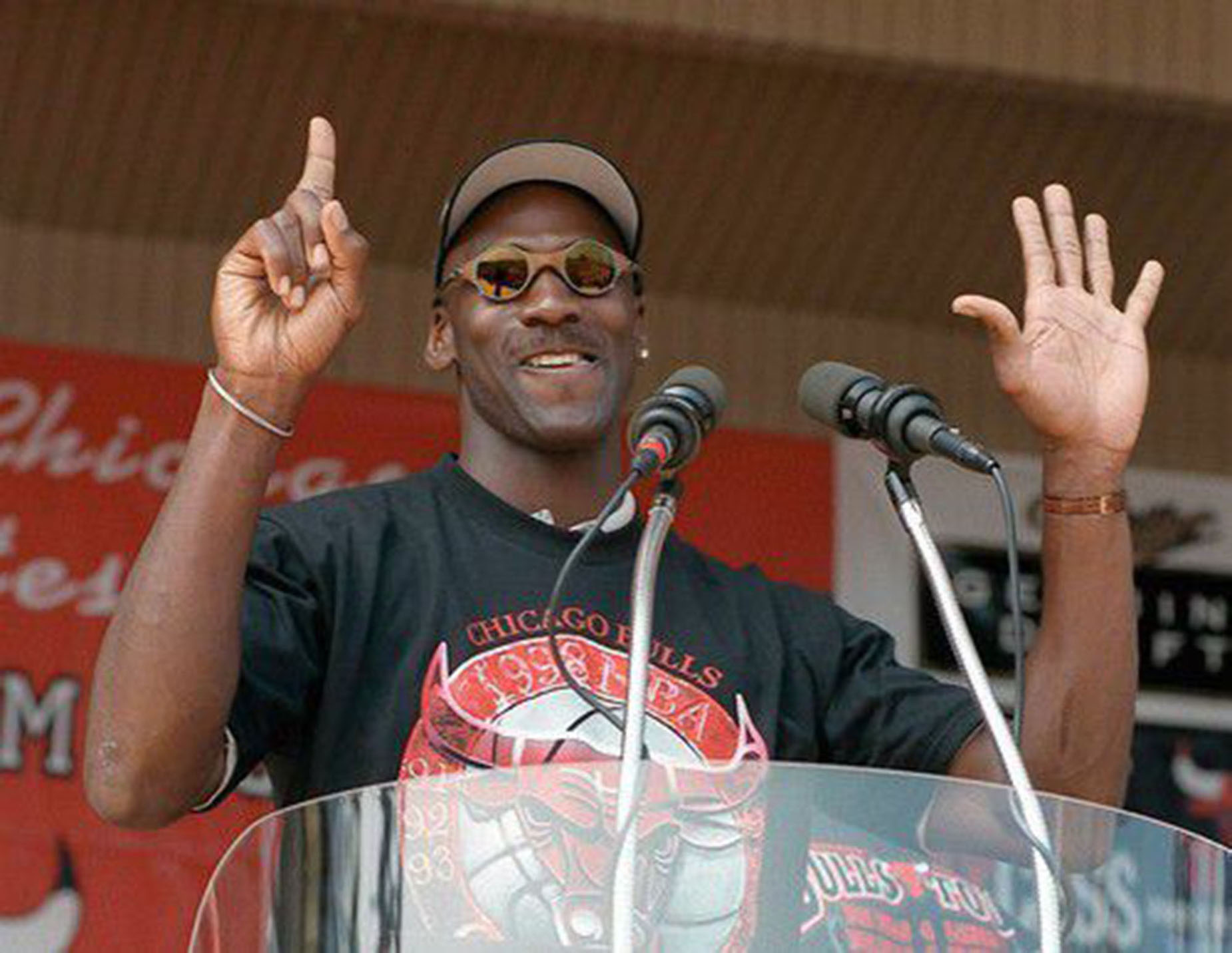 Michael Jordan holds up six fingers at a rally celebrating the Chicago Bulls sixth NBA championship.