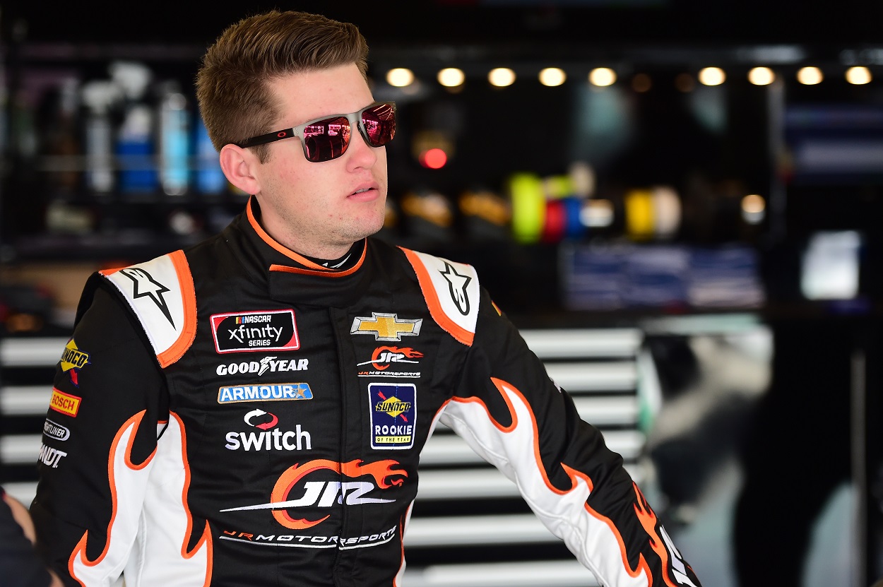 Noah Gragson waits in his garage before a practice run for a NASCAR race.